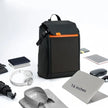 The Dropshipman Bluetooth Projection Backpack is water resistant and shown with a 16-inch laptop, headphones, folded shirt, umbrella, mouse, portable hard drive, and notebook.