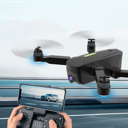 A user pilots the Dropshipman Brushless GPS Remote Control Drone Aerial Photography 4K HD, with a smartphone displaying real-time road footage from the drone’s camera, attached to the remote controller.