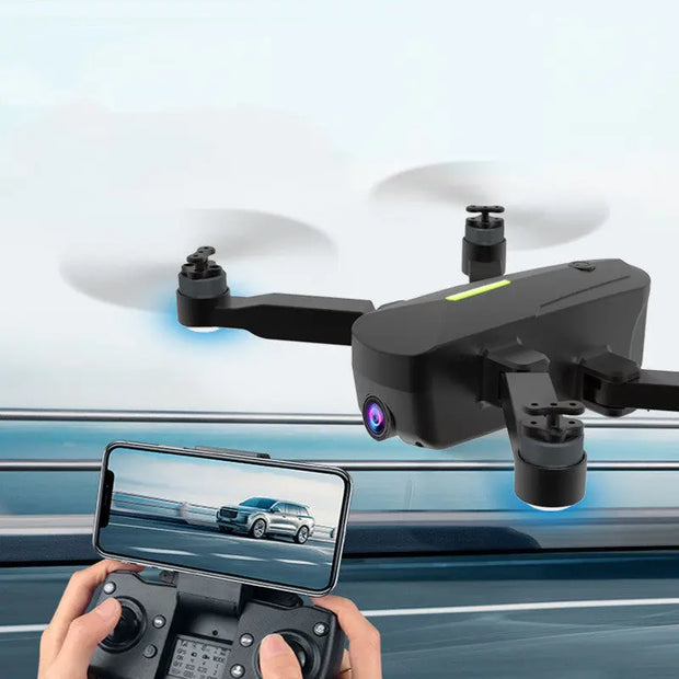 A user pilots the Dropshipman Brushless GPS Remote Control Drone Aerial Photography 4K HD, with a smartphone displaying real-time road footage from the drone’s camera, attached to the remote controller.