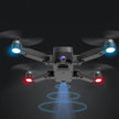 The Dropshipman Brushless GPS Remote Control Drone Aerial Photography 4K HD, in black, features a camera, blue and red LED arm lights, and emits a blue beam downward as it soars against a dark background.