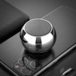 A compact, silver Dropshipman M3 Mini Colorful Wireless Speaker sits atop a modern triple-camera smartphone, both arranged on a sleek, dark surface.