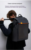 A person in a dark suit wears the Dropshipman Bluetooth Projection Backpack, a black modern bag with orange accents. The plain background highlights its pressure-reduction and multi-layered storage features.