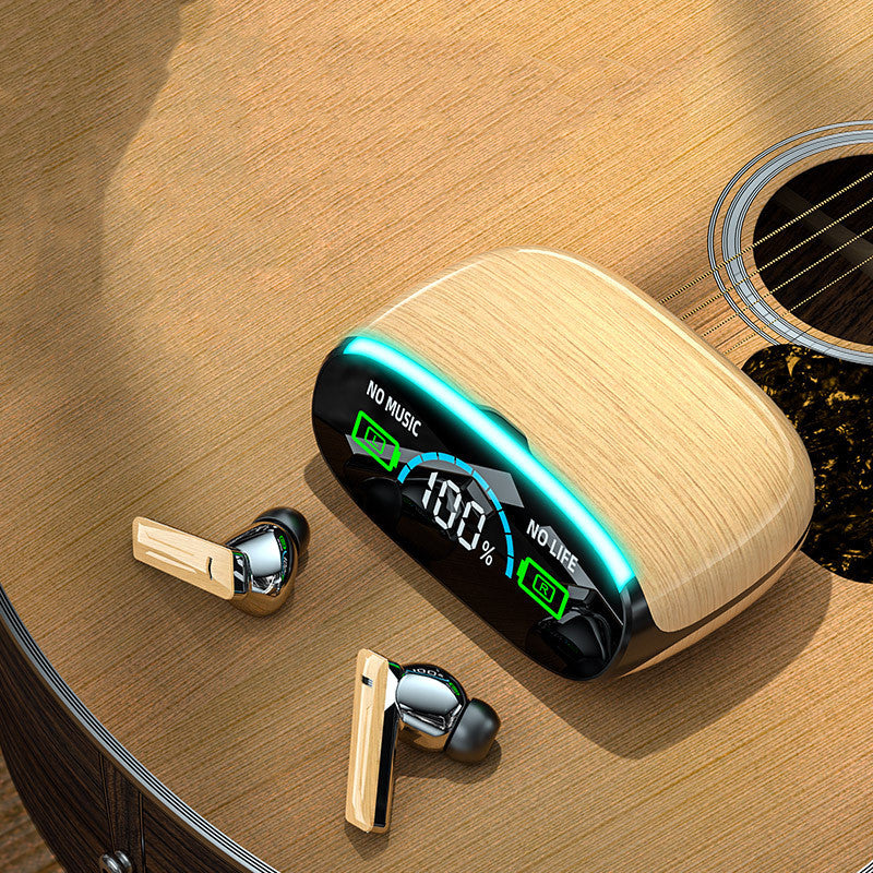 A pair of Dropshipman Wood Grain Wireless Bluetooth Earbuds with a wooden charging case featuring a digital display rests on an acoustic guitar. The case reads "NO MUSIC NO LIFE" and shows 100% battery.
