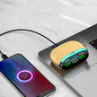 A smartphone charges on a marble surface beside a laptop, connected to Dropshipman’s Wood Grain Wireless Bluetooth Earbuds, which feature a blue-green LED, an LED screen showing 