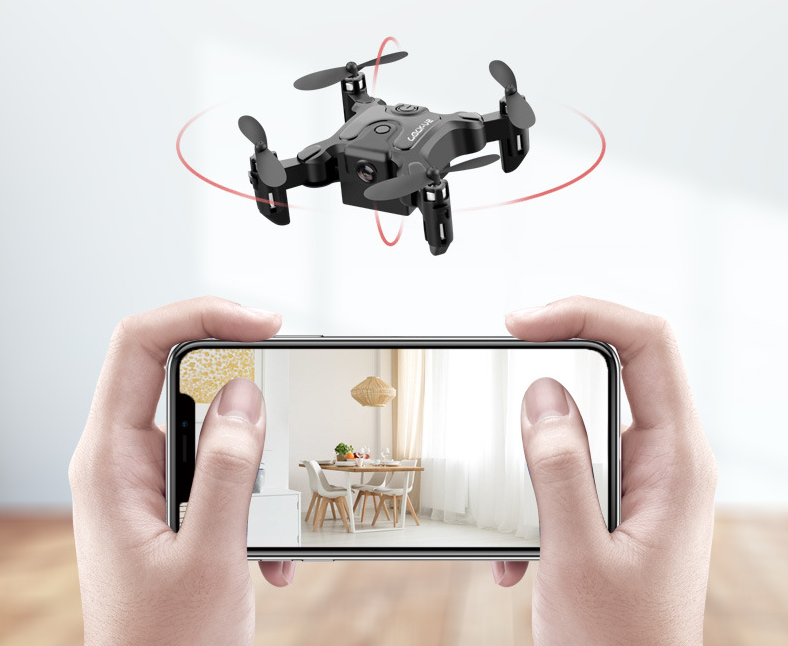 A person holds a smartphone showing a bright dining room, while the Dropshipman Mini folding drone with red indicator lights hovers indoors, highlighting its remote control quadcopter features.
