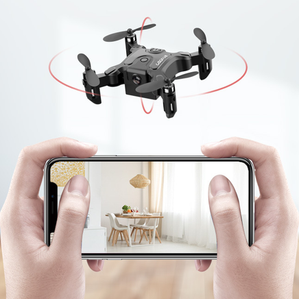 A person holds a smartphone showing a bright dining room, while the Dropshipman Mini folding drone with red indicator lights hovers indoors, highlighting its remote control quadcopter features.
