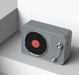 The Dropshipman Retro Vinyl Record Wireless Speaker is a modern, gray rectangular portable speaker styled like a vintage turntable, with a black grill featuring a red center and silver tonearm on a minimalist white background.