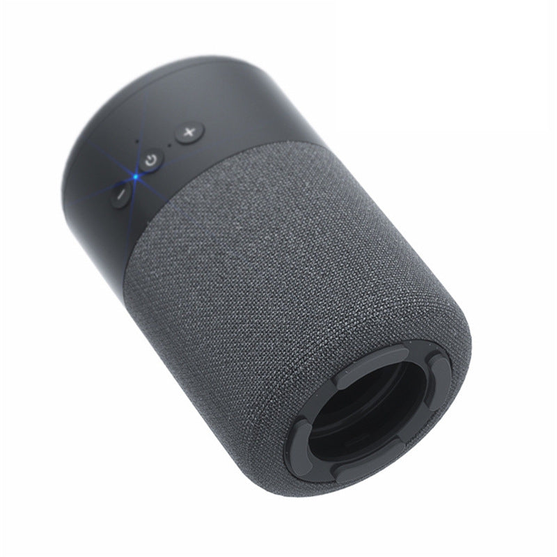 The Dropshipman B20 Bluetooth Speaker Earbud Combo is a compact audio device with a black cylindrical fabric body, top control buttons, glowing blue indicator light, and a circular base with wireless speaker opening.