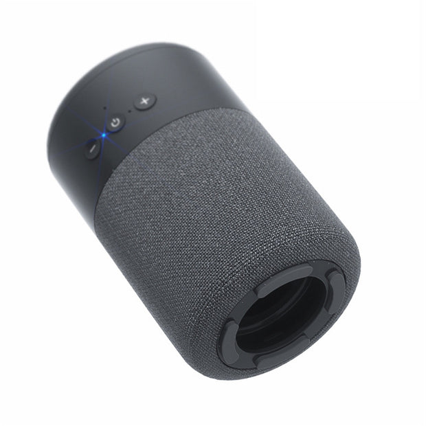 The Dropshipman B20 Bluetooth Speaker Earbud Combo is a compact audio device with a black cylindrical fabric body, top control buttons, glowing blue indicator light, and a circular base with wireless speaker opening.