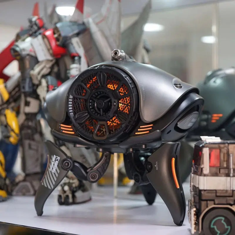 The Dropshipman Alien Tripod Bluetooth Speaker features a glowing orange core and robotic tripod design, making it a dustproof, sci-fi inspired speaker that's perfect for any fan to display on their tabletop among other mech figures.