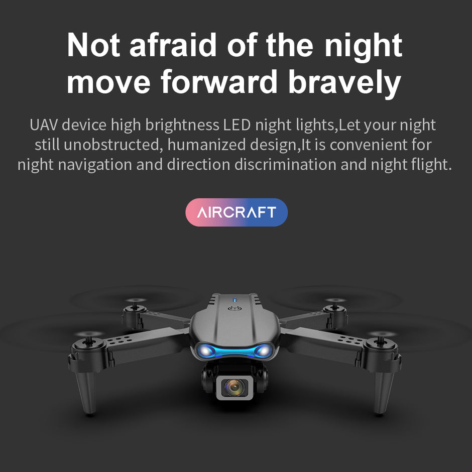 A black Dropshipman K3pro Drone E99 Folding with LED lights is shown on a dark background. Text above reads, "Not afraid of the night, move forward bravely," highlighting night flying and aerial photography.