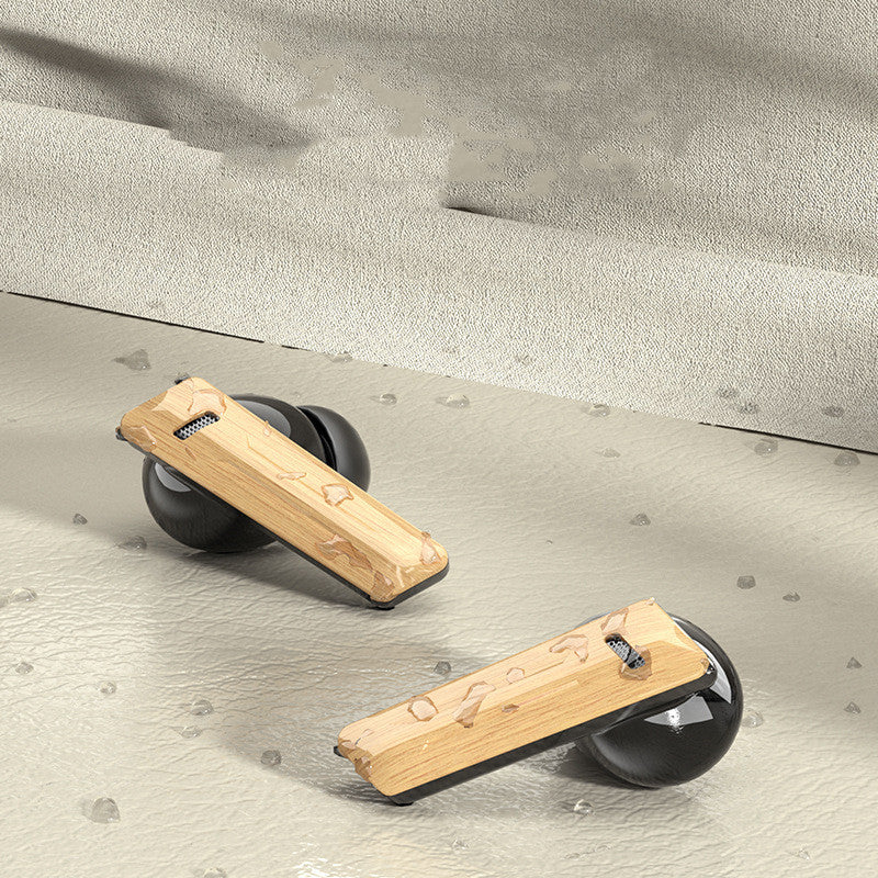 Two wooden push-up bars with black round bases rest on a textured beige surface among scattered stones—creating a stylish workout vibe that pairs perfectly with your Dropshipman Wood Grain Wireless Bluetooth Earbuds.