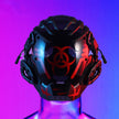The Dropshipman Bioweapon Tech Mask is a black, full-face helmet with red biohazard symbols and mechanical details, shown on a clear mannequin bust under blue and purple gradient lighting.