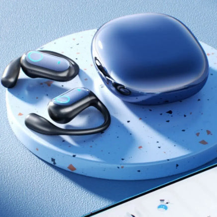 A pair of black and blue Dropshipman YYK-Q17 noise-canceling Bluetooth earbuds with ear hooks and a glossy charging case sit on a speckled blue platform beside a smartphone, offering extra-long battery life for nonstop listening.
