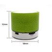 The XMSJ A9 Mini Portable Speaker from HeadphoneHeat is a compact cylindrical Bluetooth device in green, featuring a cracked finish texture and a mini portable design. It stands 52mm tall and measures 58mm in diameter. The white base with visible ports is perfect for on-the-go music lovers, making it an ideal LED MP3 Bluetooth speaker choice.