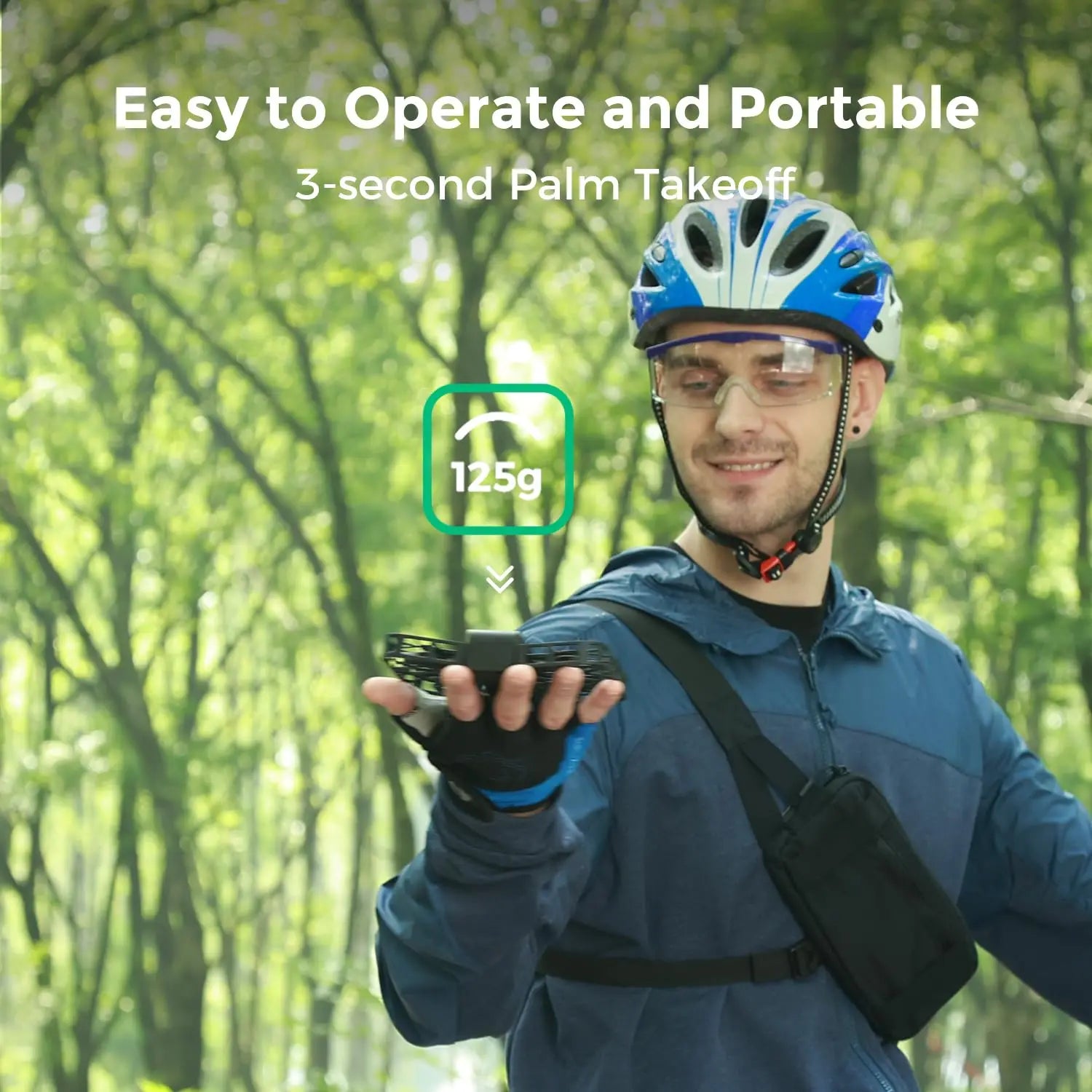 A smiling man in a blue helmet, glasses, and gloves holds the Dropshipman Hover Air X1 Pro 4K drone above his palm in a forest. Text: 