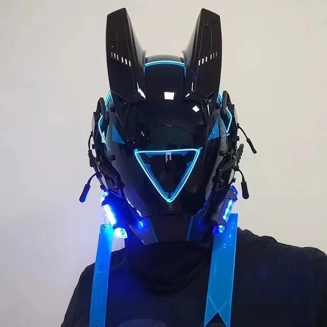 The LED Lights Cyberpunk Full Face Masks by HeadphoneHeat is a futuristic black helmet featuring glowing blue LEDs, a triangular visor, and ear-like points with extra blue lights on the sides, enhancing its high-tech look.