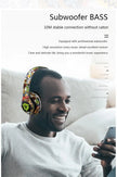 A man is smiling while wearing the vibrant Newmsnr Graffiti Foldable Wireless Bluetooth Headphones by HeadphoneHeat. He is sitting on a couch, with text above him stating 