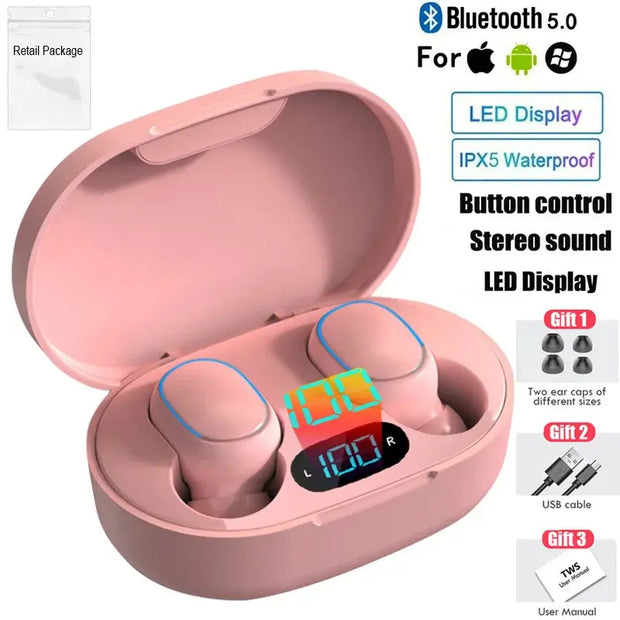 HeadphoneHeat E7s TWS Earbuds in pink, shown in an open charging case with LED display. Features Bluetooth 5.0, IPX5 waterproofing, hi-fi sound. Includes user manual, USB cable & extra ear tips. Apple & Android compatible.