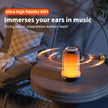 A high-end QERE Bluetooth Speaker 5W Audio by HeadphoneHeat rests on a small wooden table, surrounded by a warm orange ambiance, filling the room with sound waves. Enjoy outstanding audio quality in this inviting setup, complete with a chair and plant nearby. Text highlights 