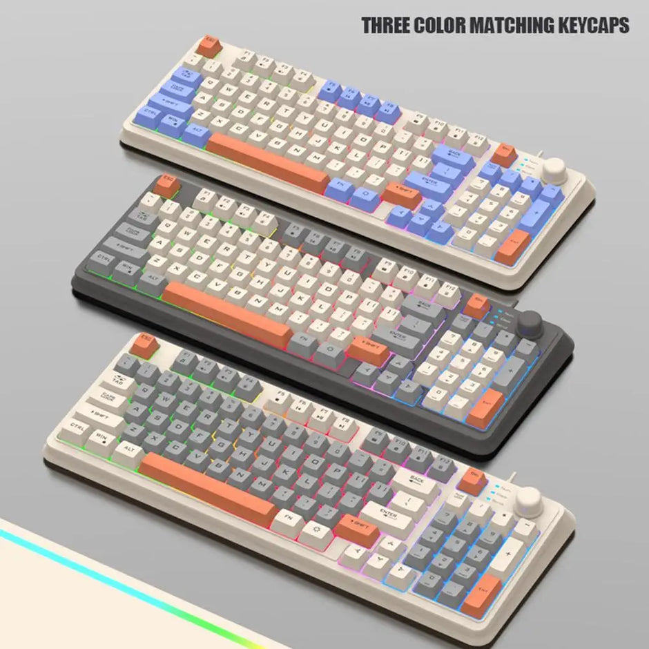 Three HeadphoneHeat K82 Mechanical Gaming Keyboards with vibrant, multi-colored keycaps are on display. Each of these wired keyboards boasts distinct color schemes, a volume knob, and USB connectivity. Text reads "Three Color Matching Keycaps.