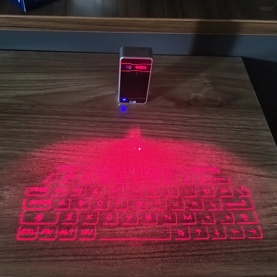 The Dropshipman Bluetooth Virtual Laser Keyboard projects illuminated keys onto a wooden desk, letting you type without a physical keyboard using red laser projection technology.