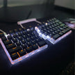The ergonomic DEBROGLIE LT78 Split Creative Mechanical Keyboard by HeadphoneHeat showcases a classy look with white backlighting. Black keycaps featuring orange lettering and Kailh switches are connected seamlessly by a coiled cable, making it ideal for any setup.