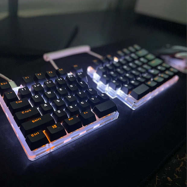 The ergonomic DEBROGLIE LT78 Split Creative Mechanical Keyboard by HeadphoneHeat showcases a classy look with white backlighting. Black keycaps featuring orange lettering and Kailh switches are connected seamlessly by a coiled cable, making it ideal for any setup.