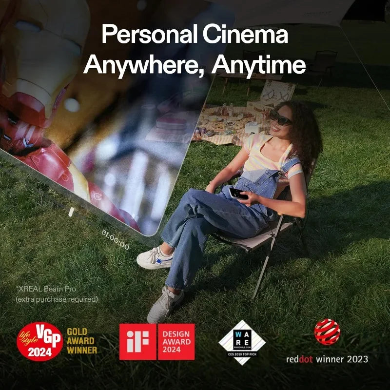A person sitting outdoors on grass, wearing XReal Air 2 Pro AR Glasses by HeadphoneHeat, enjoys a virtual screen display. Text states 