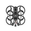 Top view of the BETAFPV Pavo20 Pro II Brushless Whoop Quadcopter by HeadphoneHeat, a compact black drone with four propellers in circular guards, 4K UHD camera housing, and two connector cables extending below.