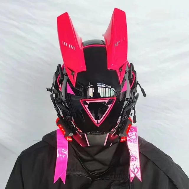 The wearer sports a HeadphoneHeat LED Lights Cyberpunk Full Face Mask, featuring pink-accented rabbit ear-shaped protrusions and a glossy black visor. Set against a white backdrop in full black attire, this helmet seamlessly combines sci-fi and anime elements for an exceptional cyberpunk vibe.