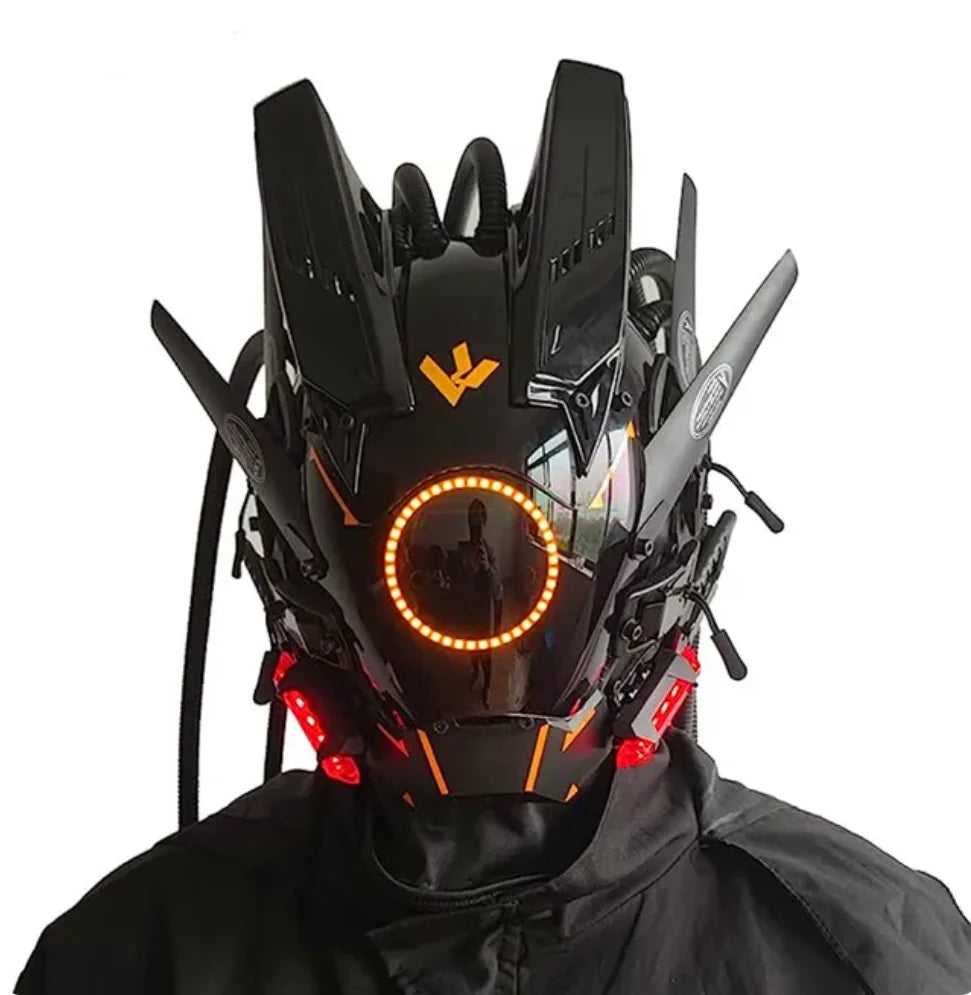 The person wears a HeadphoneHeat LED Lights Cyberpunk Full Face Mask, featuring a futuristic black design with angular features and vibrant orange-red LED lights. Protrusions accentuate its sci-fi style around an illuminated circular light.
