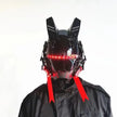 Clad in a sleek black outfit against a stark white background, a person wears the futuristic 'LED Lights Cyberpunk Full Face Mask' by HeadphoneHeat, featuring red LED lights, antenna-like extensions, angular designs, and two hanging red ribbons that create an electronic allure.