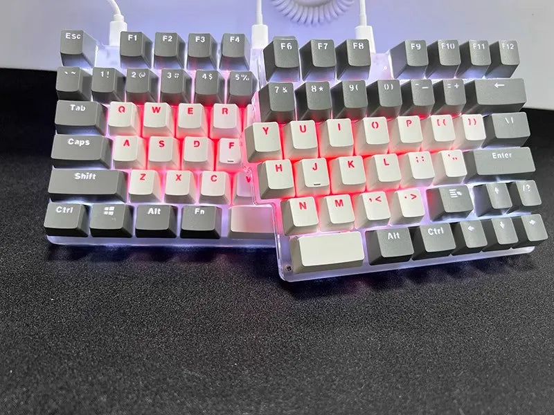 The DEBROGLIE LT78 Split Creative Mechanical Keyboard by HeadphoneHeat features an ergonomic design with Kailh switches, white and gray keycaps in a V-shape on a sleek black surface. It has red backlit keys, and the two halves are connected by a cable.