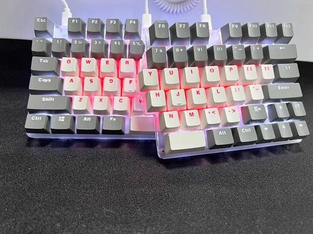 The DEBROGLIE LT78 Split Creative Mechanical Keyboard by HeadphoneHeat features an ergonomic design with Kailh switches, white and gray keycaps in a V-shape on a sleek black surface. It has red backlit keys, and the two halves are connected by a cable.