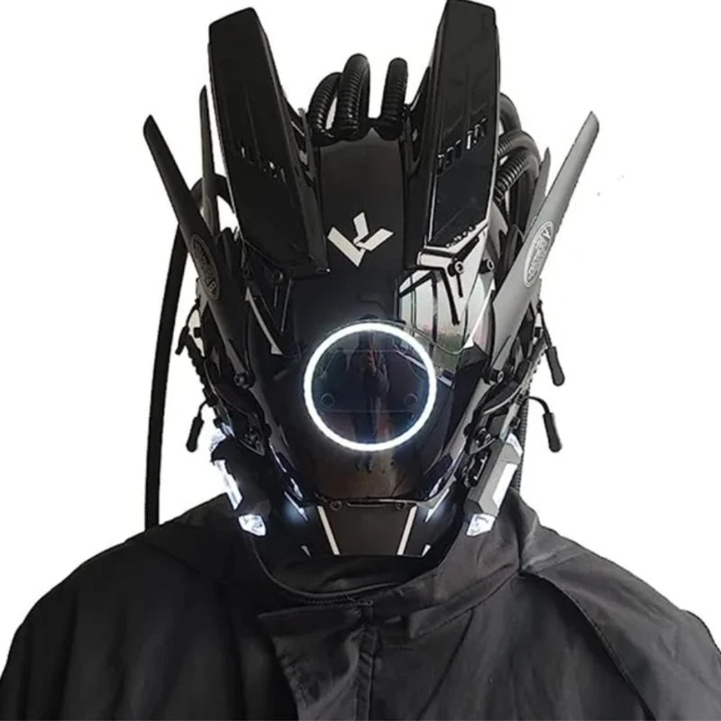 A person wears a HeadphoneHeat LED Lights Cyberpunk Full Face Mask, featuring a futuristic black design with angular details, mechanical accents, glowing white LEDs, and tubes for a high-tech look. They are dressed in dark attire.