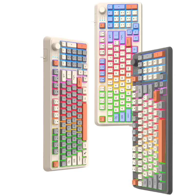 Three vibrant HeadphoneHeat K82 Mechanical Gaming Keyboards, each equipped with a USB interface, are showcased vertically on pedestals. These wired keyboards boast a lively array of rainbow-colored keys and unique keycap designs. The backdrop is a simple, light grey.