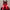 A person wears the HeadphoneHeat LED Lights Cyberpunk Full Face Mask with a red LED-lit triangular visor and ear-like protrusions. White 