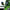 The RG METAL BUILD SIDE EVA SHOGOKI Mech Mask Cyberpunk by HeadphoneHeat features a sleek black design and anime-style visor with green details, a technical robotic look, and tech attachments. Crafted from functional material, it displays text in an unknown language on the bottom right corner.