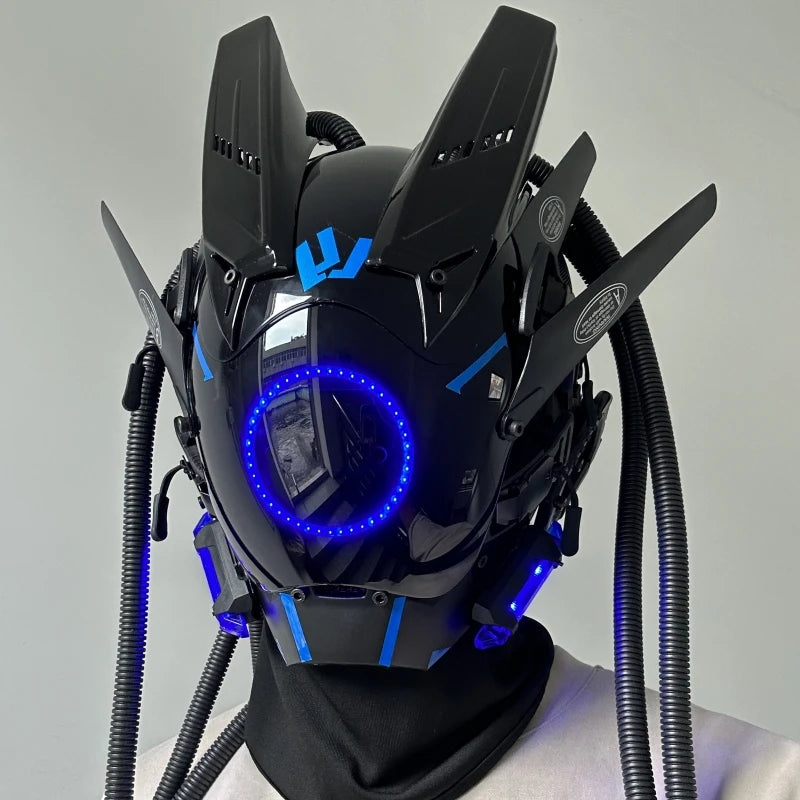 The HeadphoneHeat LED Lights Cyberpunk Full Face Masks feature angular designs, blue LED lighting with a front circular light ring, and electronic protrusions and tubing for a sci-fi robotic look.