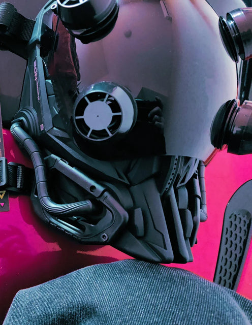 The RG METAL BUILD SIDE EVA SHOGOKI Mech Mask Cyberpunk by HeadphoneHeat features a sleek black design and anime-style visor with green details, a technical robotic look, and tech attachments. Crafted from functional material, it displays text in an unknown language on the bottom right corner.