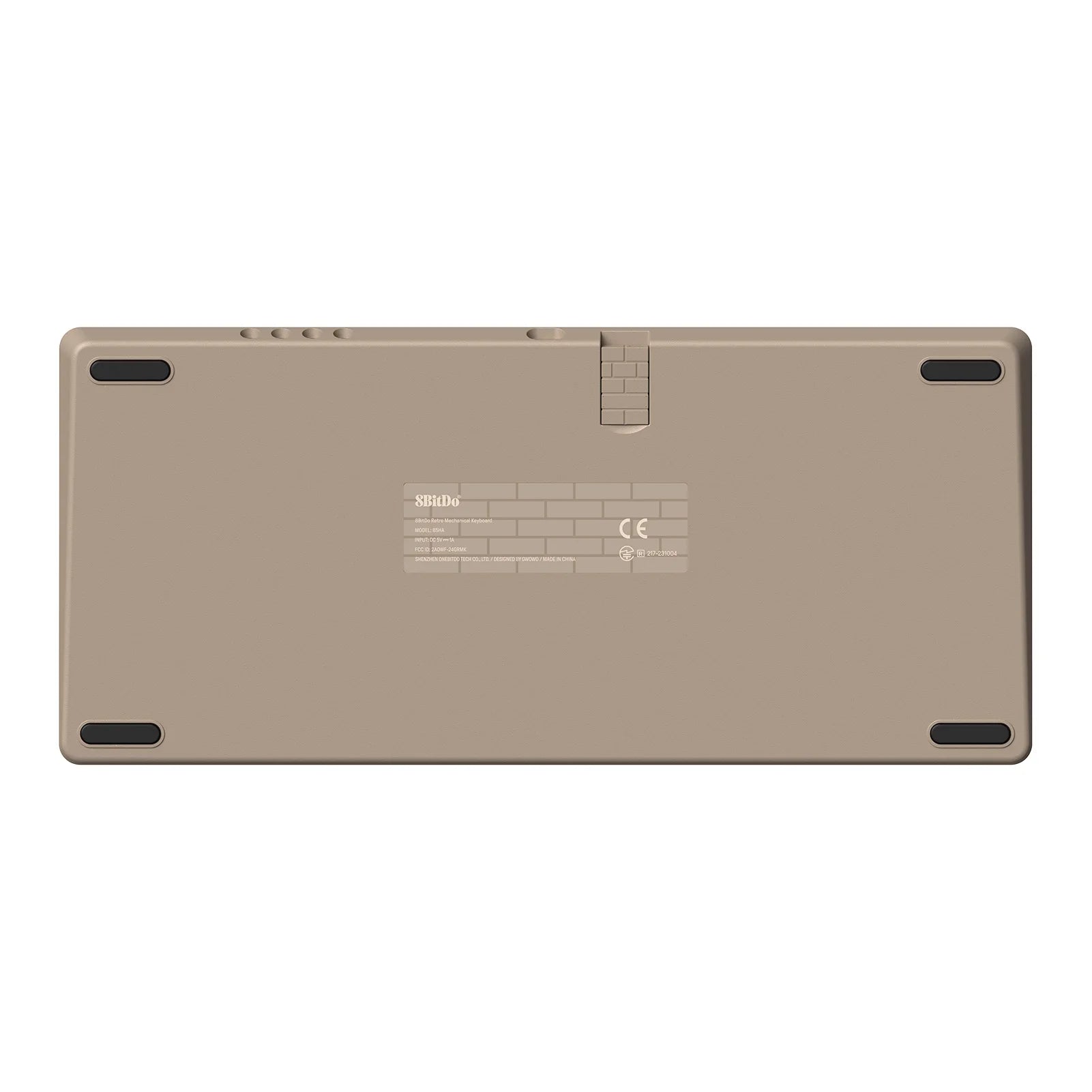 The image displays the back of a beige electronic device with rubber grips on the corners, reminiscent of an 8BitDo Retro Mechanical Keyboard design by HeadphoneHeat. It includes a label with text and symbols in the center and features a hinge-like detail at the top, enhancing its retro mechanical keyboard aesthetic.