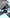 A pair of choice HYUNDAI HY-Y16 AI translator OWS Wireless Bluetooth v5.4 Earphones from HeadphoneHeat, designed for HIFI Stereo Gaming Music, rests elegantly in their open charging case amidst a laptop, smartphone, and tablet on a light blue surface. The text above reads, 
