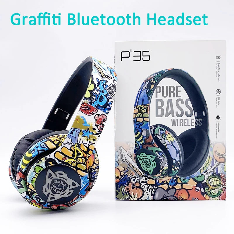 A vibrant, graffiti-themed Bluetooth headset sits beside its box, showcasing lively abstract artwork. The packaging prominently features 