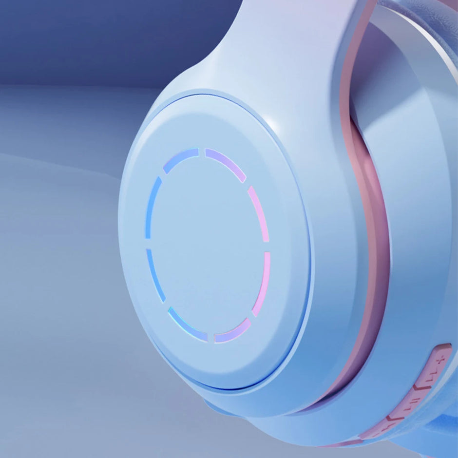 Close-up of the futuristic Wireless HiMISS HiFi Stereo Over Ear Headphones by HeadphoneHeat, featuring a sleek design in pastel blue and pink. The circular earcup glows subtly, with ergonomic ear hooks for comfort and volume control on the side amidst a smooth gradient of blue tones.