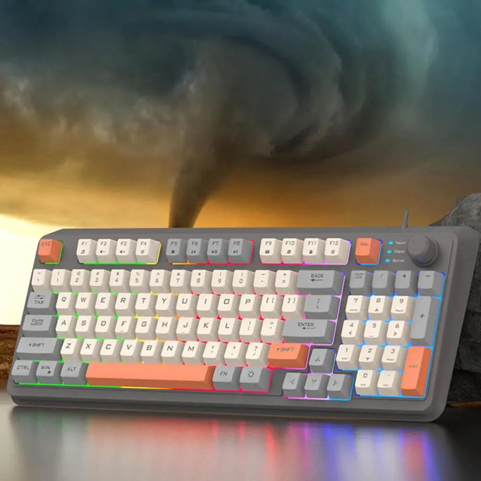 In front of a swirling tornado in the cloudy sky, a K82 Mechanical Gaming Keyboard by HeadphoneHeat with colorful keycaps and a USB interface sits dramatically. This wired mechanical keyboard features a convenient volume knob on the right side.