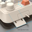 Close-up of the corner of the HeadphoneHeat K82 Mechanical Gaming Keyboard showcases an extendable metal foot for stability. This wired keyboard features white and orange keys, LED indicators, and a labeled section reading 