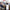 A business meeting features a smartphone prominently showing the HeadphoneHeat AI Earphone's 