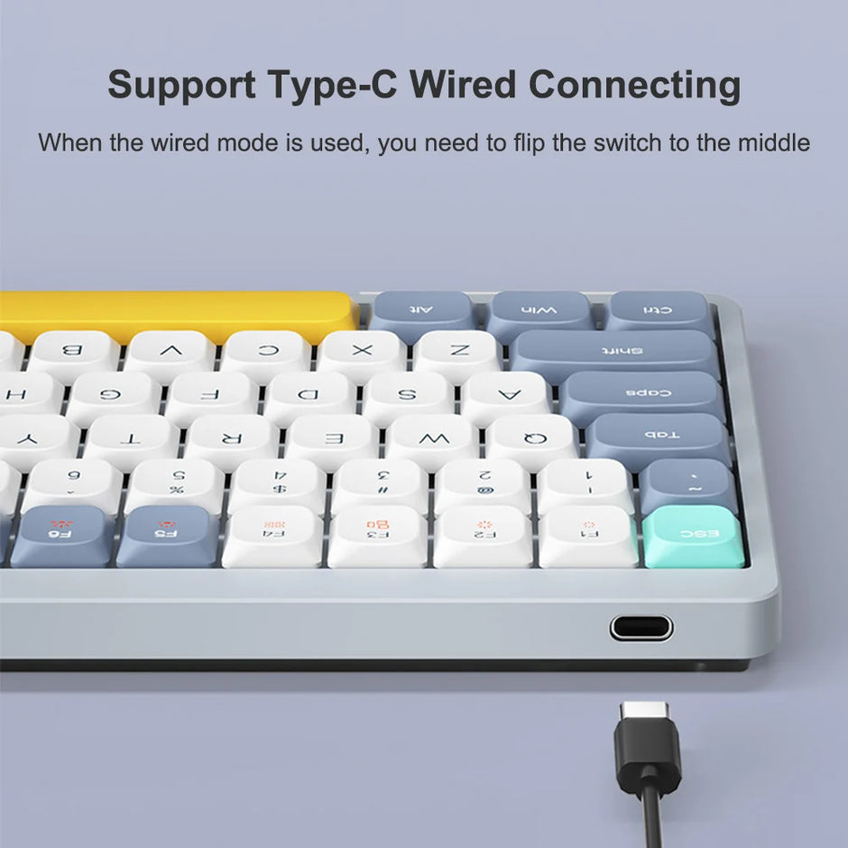 A close-up of the HeadphoneHeat Wireless Mechanical Keyboard reveals its 84 round, multicolored keys. A USB-C cable is displayed beneath, showcasing the Type-C port for wired connectivity. Instructions indicate switching to the middle for wired mode or opting for Bluetooth wireless when unplugged.