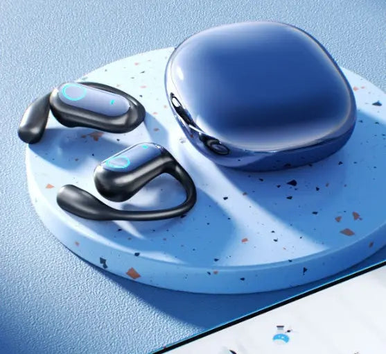 The Dropshipman YYK-Q17 Earbuds Design Noise-canceling Bluetooth earbuds in black and blue with ear hooks rest on a round speckled platform beside a matching glossy charging case atop a textured blue surface.